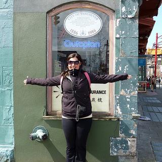 The narrowest building in the world Kairis demonstrating how wide the Sam Kee Building is. 