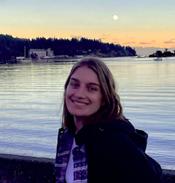 Picture of blonde woman smiling infront of the water